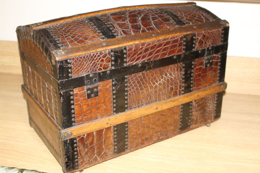 An early 20th century iron and wood bound crocodile covered miniature cabin trunk, with brass latch, length 46cm, height 31.5cm, depth